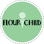 Mint-colored circle with black-dotted border, text in middle interrupted by medical symbol (two snakes around a pole) with flower on top: FlourChild